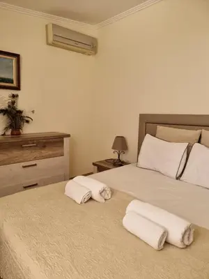 two white towels on two beds in a bedroom at Casinha da Galé in Galé