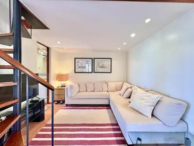 a living room with a couch and a staircase at Vilamoura Marina View 3 by Homing in Vilamoura
