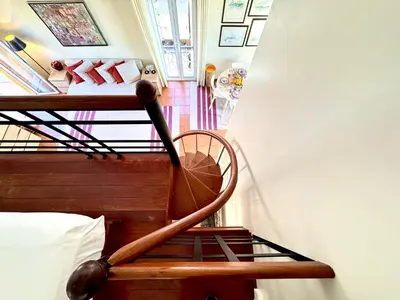 a room with a spiral staircase with a bed at Vilamoura Marina View 3 by Homing in Vilamoura