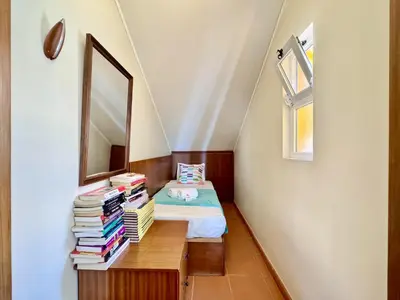 a bedroom with a bed and a table with books at Vilamoura Marina View 3 by Homing in Vilamoura