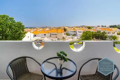 a table and chairs on a balcony with a view at Alamos - Dream Lodging in Albufeira