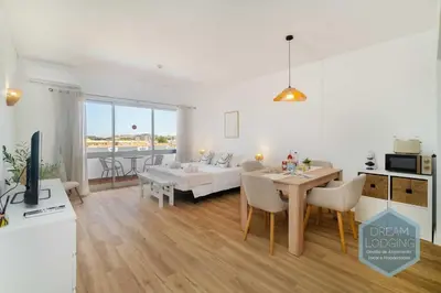 a living room with a table and a dining room at Alamos - Dream Lodging in Albufeira