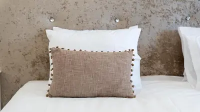 a white bed with a pillow on it at Vivenda Neves in Albufeira by LovelyStay in Vale de Pedras