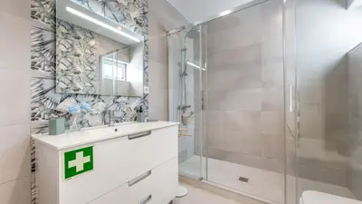 a bathroom with a shower and a sink and a mirror at Vivenda Neves in Albufeira by LovelyStay in Vale de Pedras