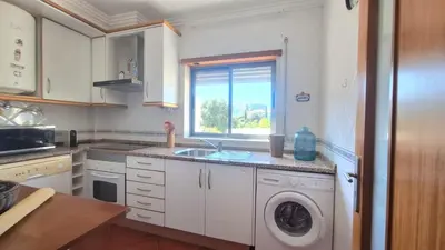 a kitchen with a sink and a washing machine at albufeira sweety house in Albufeira