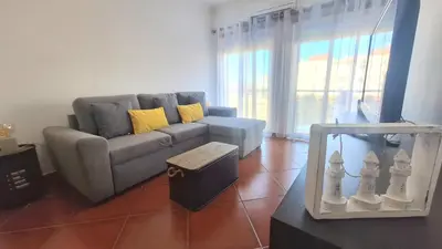 a living room with a couch and a table at albufeira sweety house in Albufeira