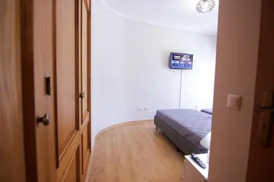 a bedroom with a bed and a hallway with a door at Modern 3-bedroom Retreat in Faro's City Center in Faro