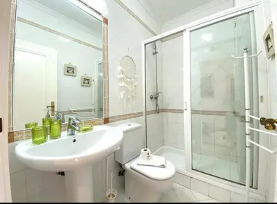 a bathroom with a sink and a toilet and a shower at Vilamoura Central in Quarteira