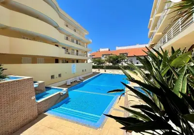 a swimming pool in the middle of a building at Vilamoura Central in Quarteira