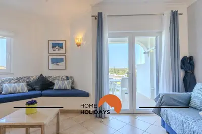 a house with a yard with chairs and a table at #322 Albufeira Family Stay by Home Holidays in Albufeira
