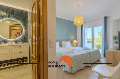 a bedroom with a bed and a mirror at #322 Albufeira Family Stay by Home Holidays in Albufeira