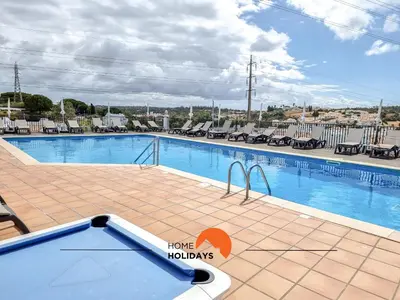 a large swimming pool at a resort with chairs at #322 Albufeira Family Stay by Home Holidays in Albufeira