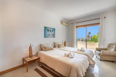 a bedroom with two beds and a large window at Apartment Galé Mar By Zimzala & Bedzy in Guia