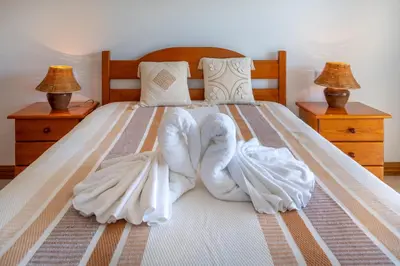 a bed with two white towels and two lamps at Apartment Galé Mar By Zimzala & Bedzy in Guia