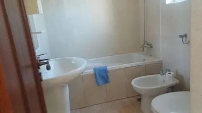a bathroom with a sink and a tub and a toilet at Casa Gomez C in Albufeira