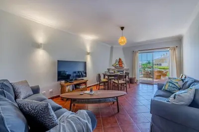 a living room with a couch and a table at Sao Rafael TownHouse with Pool in Albufeira