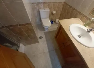 a bathroom with a white sink and a toilet at Villa David in Albufeira