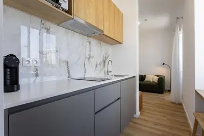 a kitchen with a sink and a counter top at Carmo Suites in Faro