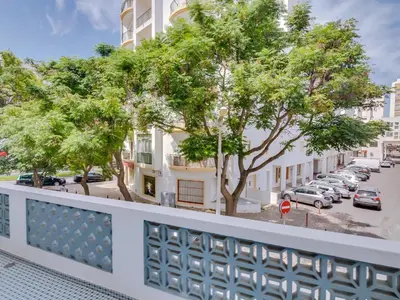 a balcony with a view of a parking lot at Casa da Avó Marquinhas in Quarteira