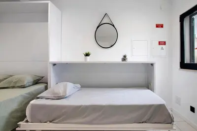 a bedroom with two beds and a mirror on the wall at Mi Casa Es Su Casa Nº1 in Albufeira