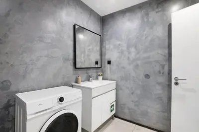 a bathroom with a white washing machine and a sink at Mi Casa Es Su Casa Nº2 in Albufeira