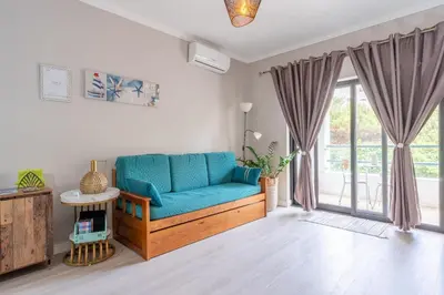 a table with a plant on it next to a lamp at Cartaia Apartamento Leste in Quarteira