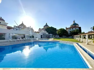 a large blue swimming pool in front of a building at Vilamoura Central 12 With Pool by Homing in Vilamoura