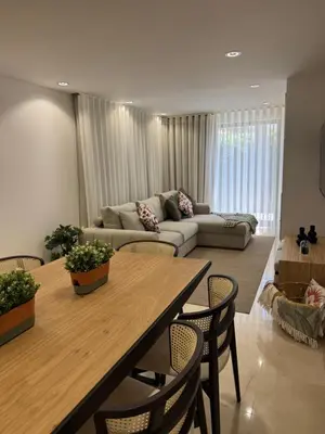 a living room with a table and a couch at HC2 Village Vilamoura in Quarteira