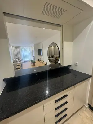 a kitchen with a counter top and a mirror at HC2 Village Vilamoura in Quarteira