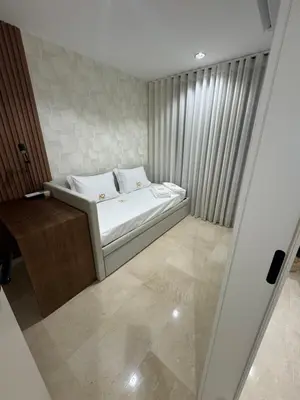 a small bedroom with a white bed and curtains at HC2 Village Vilamoura in Quarteira