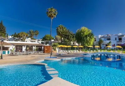 a bedroom with two beds with towels on them at Dream House in Clube Albufeira in Albufeira