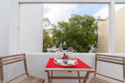a bedroom with a bed with white pillows at Casinha Amorosa in Faro