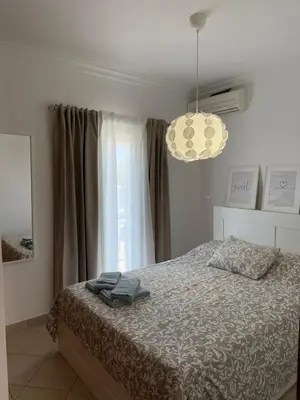 a bedroom with a bed and a large window at Townhouse Sol&Mar Vilamoura in Vilamoura