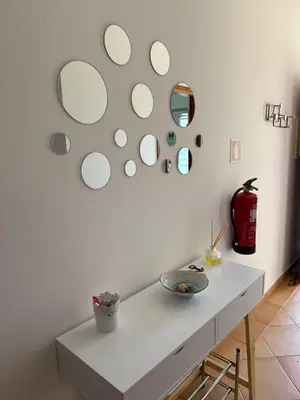 a room with a table with mirrors on the wall at Townhouse Sol&Mar Vilamoura in Vilamoura
