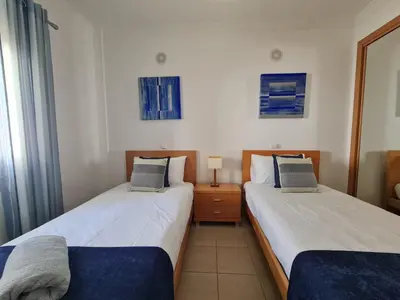 two beds in a hotel room with two at Encosta Sao Jose - Apartment BF in Albufeira