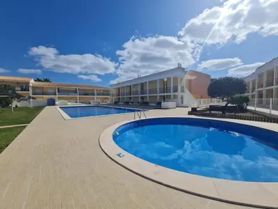 a large swimming pool in front of a building at Encosta Sao Jose - Apartment BF in Albufeira