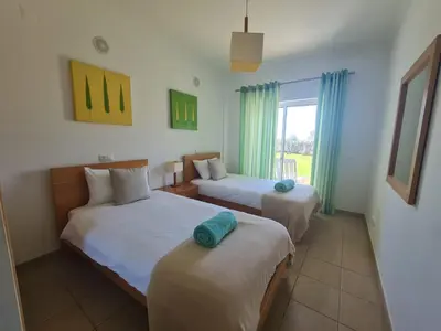 two beds in a room with a window at Encosta Sao Jose - Apartment BF in Albufeira
