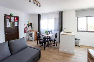 a living room with a couch and a table at Go4Portugal - Solaina - Modern Condo with AC and Private Balcony in Albufeira