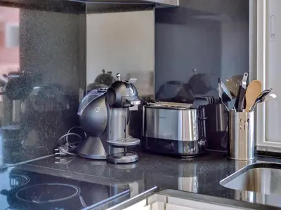 a kitchen counter with appliances on top of it at T2 Moderno e Renovado a 500m da praia de Quarteira in Quarteira
