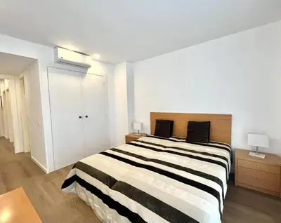 a bedroom with a large bed with black and white stripes at The Navigator Olympus in Quarteira