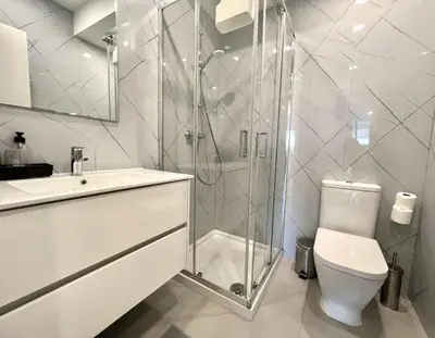 a bathroom with a shower and a toilet and a sink at The Navigator Olympus in Quarteira