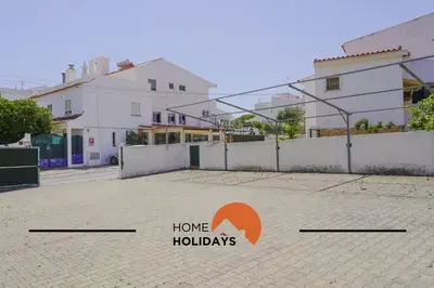 a house with a sign that says home holidays at #240 Beach House - Casa da Balaia by Home Holidays in Olhos de Água