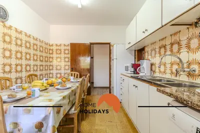 a kitchen with a table with fruit on it at #240 Beach House - Casa da Balaia by Home Holidays in Olhos de Água