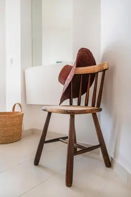 a balcony with white chairs and a view of a yard at Clube Albufeira - 2BR Pool, Kids Club & Family Fun in Albufeira