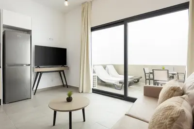 a living room with a couch and a television at Castilhos 1 - City center by HD in Faro
