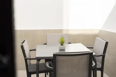 a table and chairs with a plant on top of it at Castilhos 1 - City center by HD in Faro
