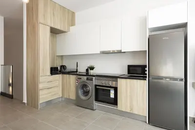 a kitchen with a washer and a dishwasher at Castilhos 2 - City center by HD in Faro
