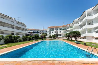 a swimming pool in front of a apartment building at O Canto do Oceano T2 Albufeira in Albufeira