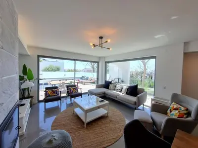 a living room with couches and a table at Luxury Design Villa (Private Pool & Jacuzzi) in Albufeira