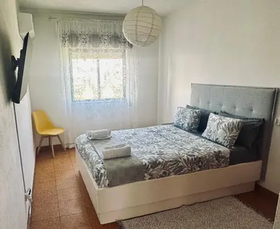 a bedroom with two beds and a window at Milennium Holiday Apartment in Quarteira